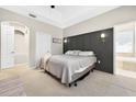 Relaxing bedroom featuring neutral tones, a decorative headboard, with a view of the ensuite at 33316 Irongate Dr, Leesburg, FL 34748