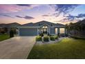 Charming home featuring a well-manicured lawn, elegant landscaping, and a two-car garage at 3566 Gentle Ter, The Villages, FL 32163