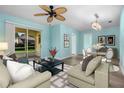Bright living room featuring modern furnishings, sleek flooring, and sliding glass doors to the lanai at 3586 Eversholt St, Clermont, FL 34711