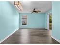 Open-concept living room featuring sleek floors, natural light, and smooth flow to outdoor area at 3586 Eversholt St, Clermont, FL 34711