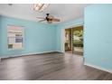 Spacious living room with modern flooring and sliding glass doors for ample natural light and indoor-outdoor flow at 3586 Eversholt St, Clermont, FL 34711