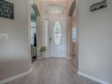 Bright foyer with wood-look floors and an ornate front door at 359 Blue Branch St, Eustis, FL 32736