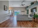 Open concept living room featuring hardwood floors, a ceiling fan, and sliding doors to the pool at 359 Blue Branch St, Eustis, FL 32736