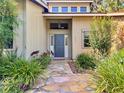 Inviting entrance with stone pathway leading to a stylish front door and manicured landscaping at 3664 Se 45Th Pl, Ocala, FL 34480