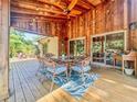 Charming outdoor patio with wood ceiling, ceiling fan, dining set, and string lights at 3664 Se 45Th Pl, Ocala, FL 34480