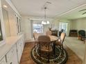 Cozy dining room area featuring a round table with seating for four, and storage at 424 Hawthorne Blvd, Leesburg, FL 34748