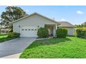 Charming single-story home with a well-manicured lawn and attached one car garage at 512 Galloway Ct, Leesburg, FL 34788