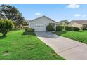 Charming single-story home with a well-manicured lawn and attached one car garage at 512 Galloway Ct, Leesburg, FL 34788