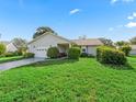 Charming single-story home with a well-manicured lawn and attached one car garage at 512 Galloway Ct, Leesburg, FL 34788