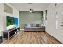 Cozy living room featuring a ceiling fan, wood-look floors, and a neutral color palette at 520 Dora Ave, Tavares, FL 32778