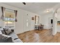 Bright living room with wood-look flooring, white walls, and ample natural light at 520 Dora Ave, Tavares, FL 32778