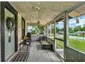 Inviting screened porch with seating area, offering a relaxing outdoor space at 520 Dora Ave, Tavares, FL 32778