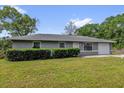 Charming one-story home with a well-manicured lawn and mature landscaping at 5390 Nw 12Th Pl, Ocala, FL 34482