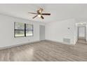 Light filled living space with wood look flooring and ceiling fan at 5390 Nw 12Th Pl, Ocala, FL 34482