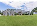 Charming home with a lush front lawn and manicured landscaping at 5429 County Road 125, Wildwood, FL 34785