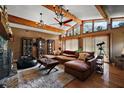 Open living room with exposed wood beams, vaulted ceiling, hardwood floors, and ample natural light at 672 E Belt Ave, Bushnell, FL 33513