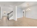 Bright, open living area with neutral tile flooring, a staircase, and views into other rooms at 752 Sandy Bar Dr, Winter Garden, FL 34787