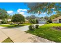 Single Gathering home in a quiet neighborhood boasts a well-maintained lawn and landscaping at 8045 Waterbury Way, Mount Dora, FL 32757