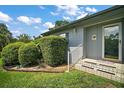 Close up of the front entrance featuring manicured hedges and a cheerful sunflower decoration at 902 Lakeview Dr, Eustis, FL 32726