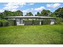 Charming single-story home featuring a well-maintained lawn and carefully trimmed hedges at 902 Lakeview Dr, Eustis, FL 32726