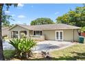 A charming single-story home boasts a lush front yard, freshly landscaped flower beds, and a well-maintained driveway at 910 Rangeline Rd, Longwood, FL 32750