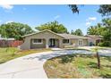 Charming single-story home featuring a well-manicured front lawn and a freshly poured circular concrete driveway at 910 Rangeline Rd, Longwood, FL 32750