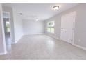 Bright and spacious living room featuring tile floors, a ceiling fan, and large windows for natural light at 10128 County Road 229, Oxford, FL 34484