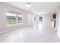 Bright living room featuring tile floors, recessed lighting, and large windows providing ample natural light at 10128 County Road 229, Oxford, FL 34484