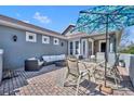 Beautiful outdoor patio space, perfect for dining, lounging, or enjoying sunny days with shade umbrella at 109 Falling Acorn Ave, Groveland, FL 34736