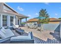 The outdoor patio features a comfortable seating area, a dining table, and a brick-paved deck at 109 Falling Acorn Ave, Groveland, FL 34736