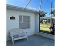 Inviting front porch featuring a comfortable chair and a view of the street at 1105 Hazelnut Dr, Leesburg, FL 34748