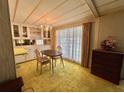 Cozy dining room featuring vintage chandelier, carpet and built in china cabinet at 112 Caladium St, Leesburg, FL 34748
