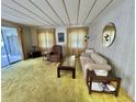 The cozy living room is flooded with natural light, complete with comfortable seating at 112 Caladium St, Leesburg, FL 34748