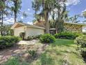 Charming single-Gathering home showcases well-maintained landscaping and a two-car garage at 11401 Cypress Dr, Clermont, FL 34711