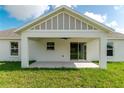 A covered back patio featuring concrete flooring, a ceiling fan, and access to the grassy backyard at 13334 Sw 107Th St, Dunnellon, FL 34432