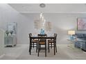 Elegant dining room featuring a modern chandelier and stylish decor at 17439 Promenade Dr, Clermont, FL 34711