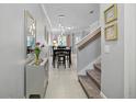 Inviting entryway with a view of the dining area and staircase at 17439 Promenade Dr, Clermont, FL 34711