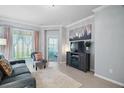 Comfortable living room with tile floors and a view of the backyard at 17439 Promenade Dr, Clermont, FL 34711