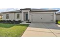 Well-maintained home with a two-car garage, neutral paint, and landscaped front yard adding curb appeal at 1940 Piedmont Ct, Mascotte, FL 34753