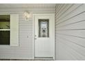 Elegant front door with decorative glass and sidelight and exterior light at 2207 Crawford Ct, The Villages, FL 32162