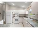 Bright kitchen featuring white appliances, countertops, and ample cabinet space at 2207 Crawford Ct, The Villages, FL 32162