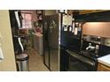 Functional kitchen with stainless steel appliances and space-saving storage solutions at 235 Rockmoore Ct, Deland, FL 32720