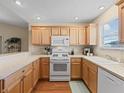 Well-lit kitchen featuring warm wood cabinetry, essential appliances, and a functional layout for efficient cooking and meal prep at 2369 Five Forks Trl, The Villages, FL 32162