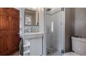 Modern bathroom with tiled shower and pebble floor, along with a sleek vanity sink at 256 Carroll St, Clermont, FL 34711