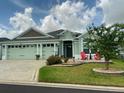 Charming single-story home with two-car garage, manicured lawn, and welcoming front porch area at 2648 Maymont Ct, The Villages, FL 32163
