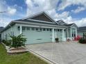 Charming single-story home with three-car garage, manicured lawn, and welcoming front porch area at 2648 Maymont Ct, The Villages, FL 32163