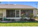 Enclosed screened porch, perfect for relaxing and enjoying the outdoors, with lush greenery surrounding the space at 27141 Racquet Cir, Leesburg, FL 34748