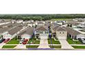 Aerial view of home and neighborhood showing other homes and landscaping in a Gathering-friendly community at 30422 Pintail Dr, Leesburg, FL 34748