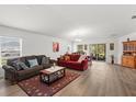 Bright and open living room with hardwood floors and sliding glass doors to the backyard at 3260 Casa Del Rey Ave, Kissimmee, FL 34746