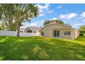 Expansive backyard with lush green grass, a privacy fence, and patio, offering ample space for recreation at 33234 Kaylee Way, Leesburg, FL 34788